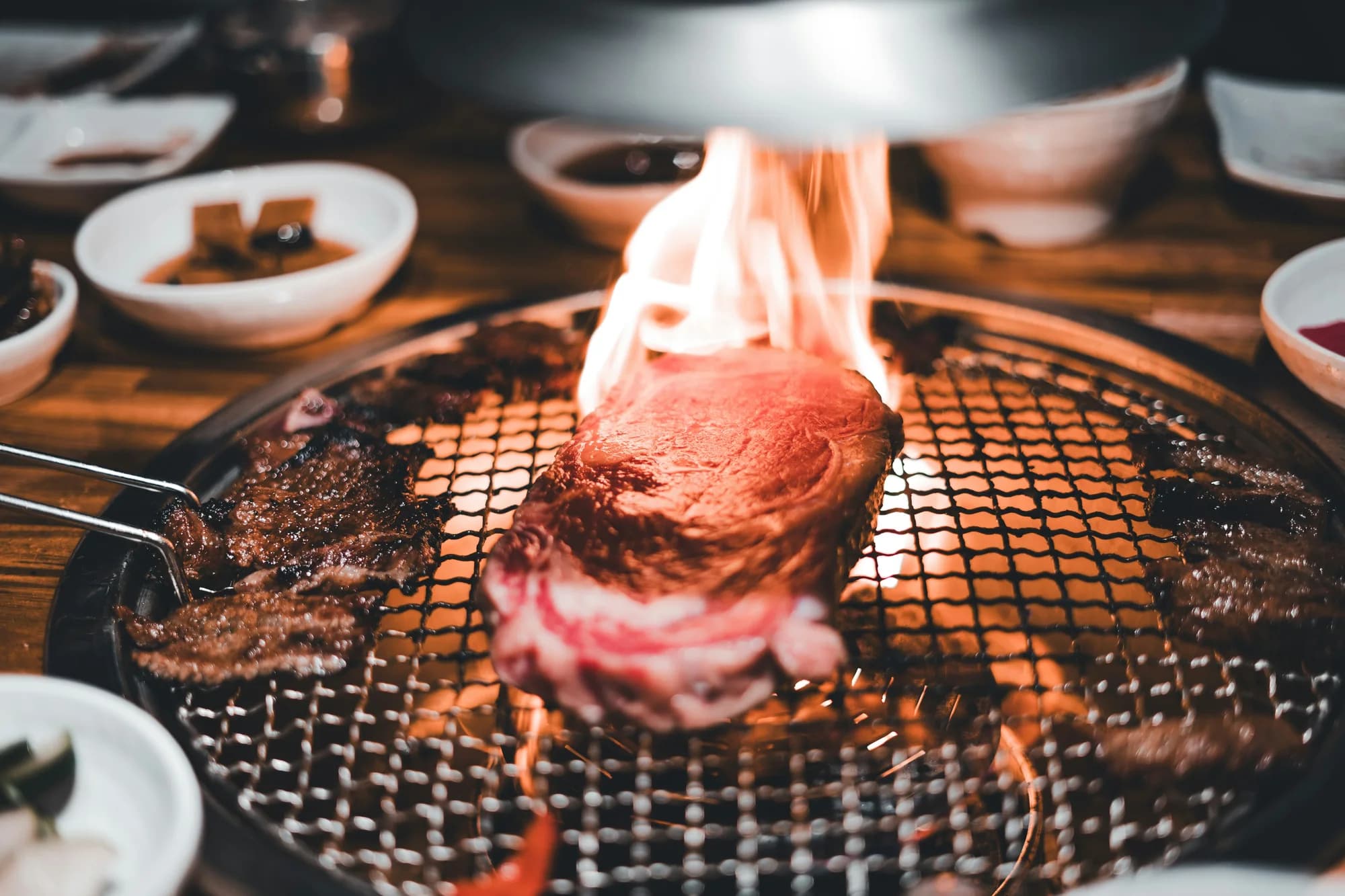 Steak cooking on a grill — representative photo, not taken at Brett