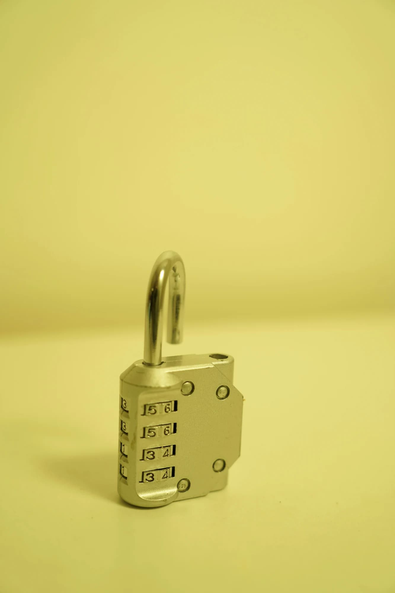 A combination combination lock on a yellow background — representative photo, not taken at Escape Glasgow