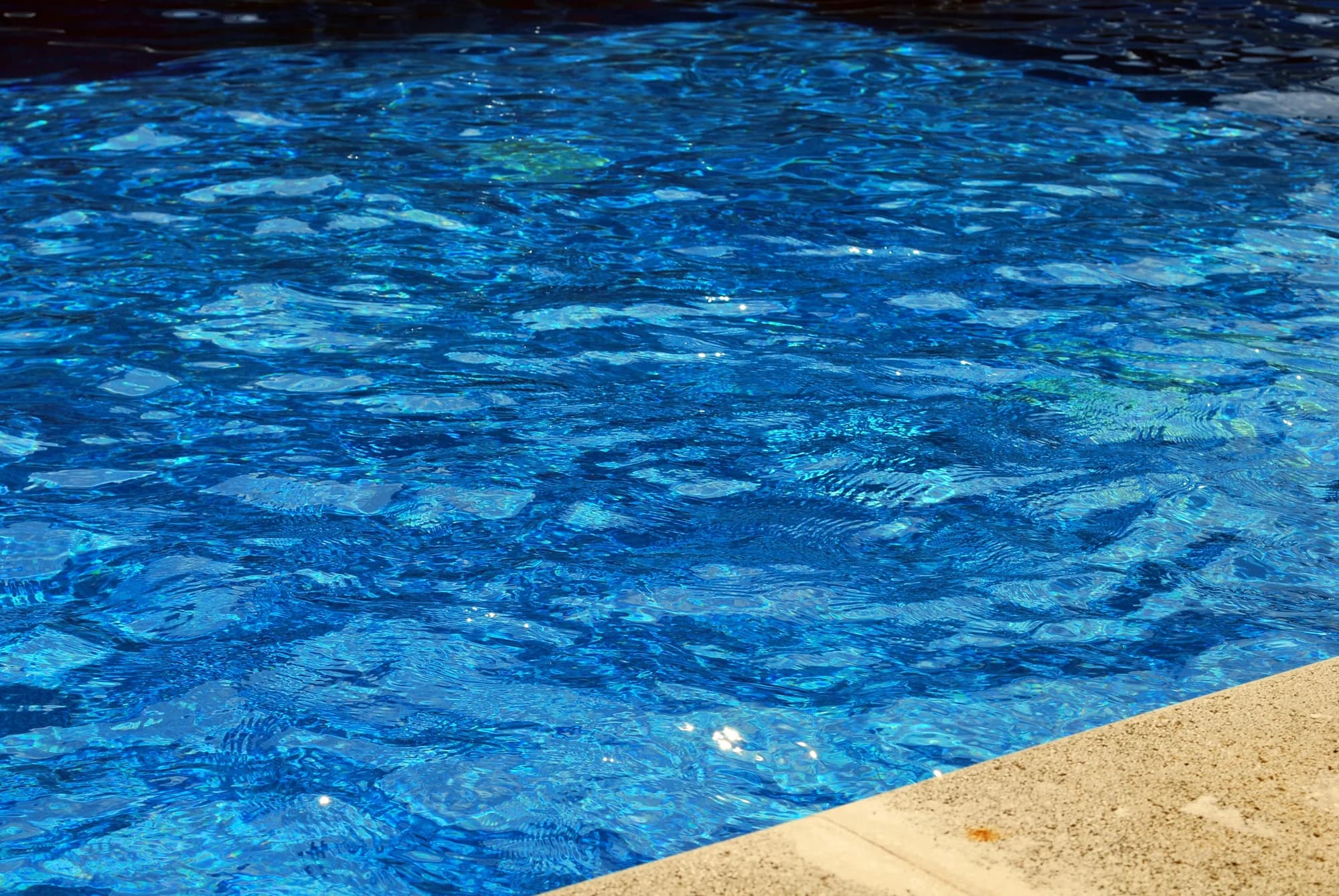 Close-up of swimming-pool water and the pool edge — representative photo, not taken at Glasgow Club Springburn