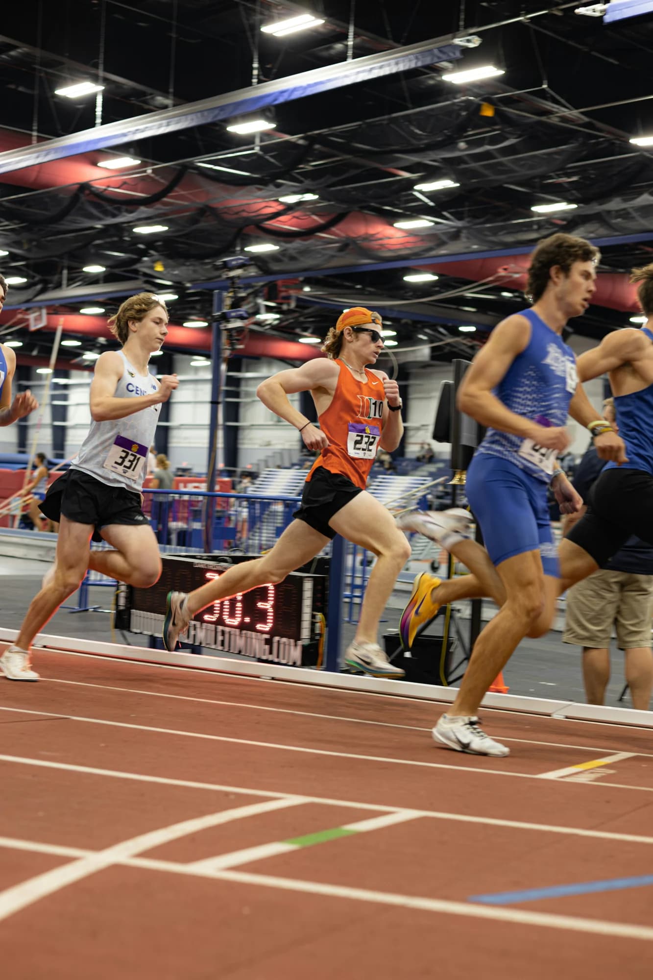 Athletes race on an indoor track — representative photo, not taken at Glasgow International Arena