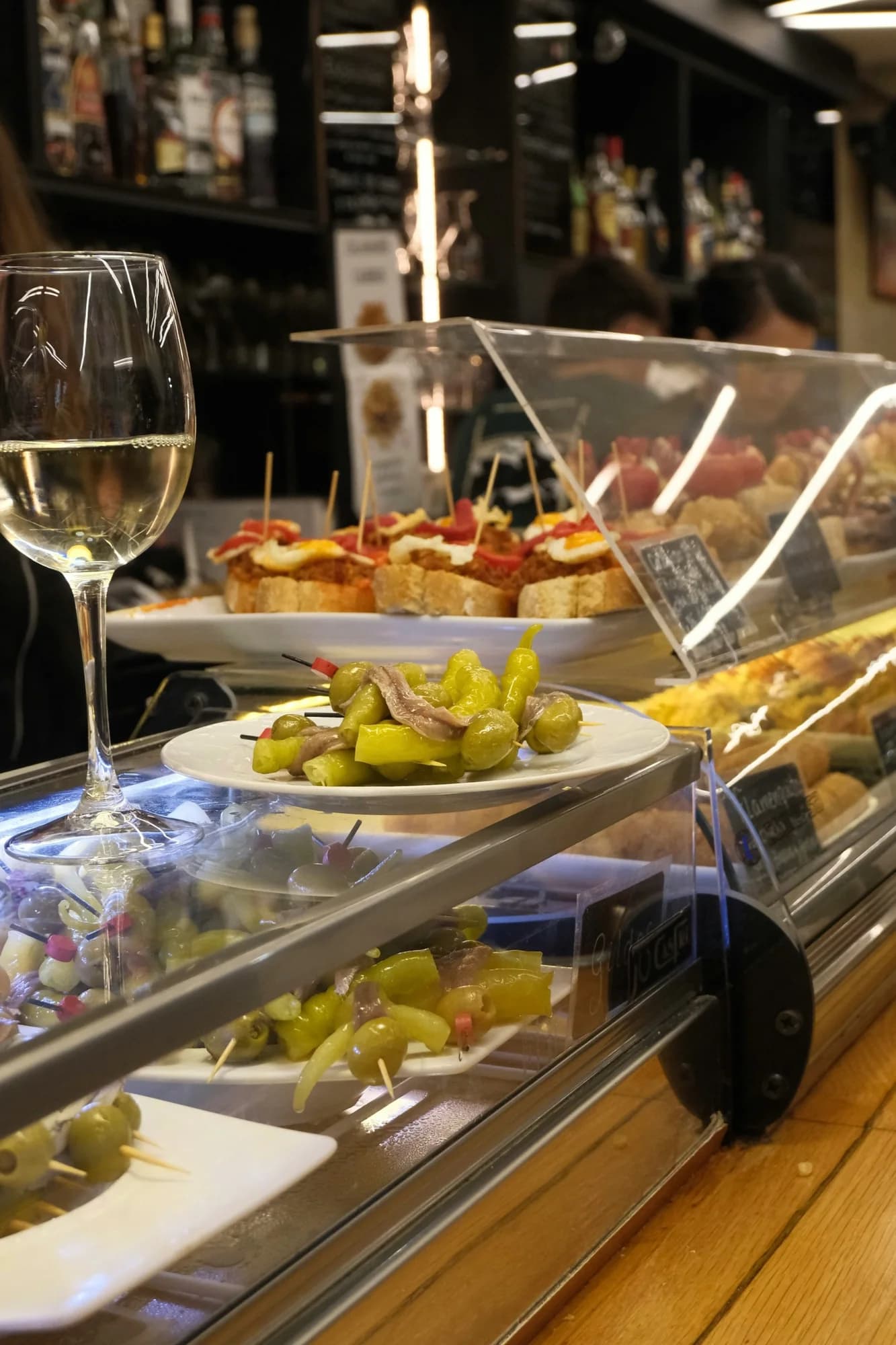 White wine and small plates — representative photo, not taken at Gloriosa