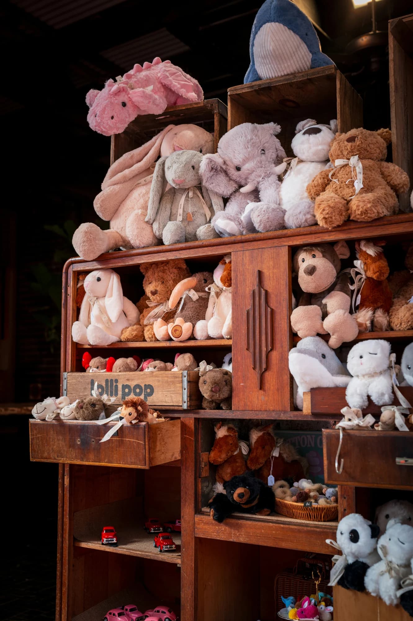 A collection of stuffed animals on wooden shelves. — representative photo, not taken at Hamleys — St. Enoch