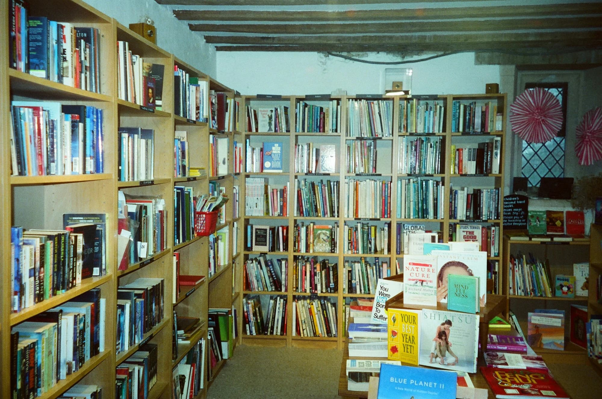 Bookshelves filled with books in a cozy bookstore. — representative photo, not taken at Herrigan Books