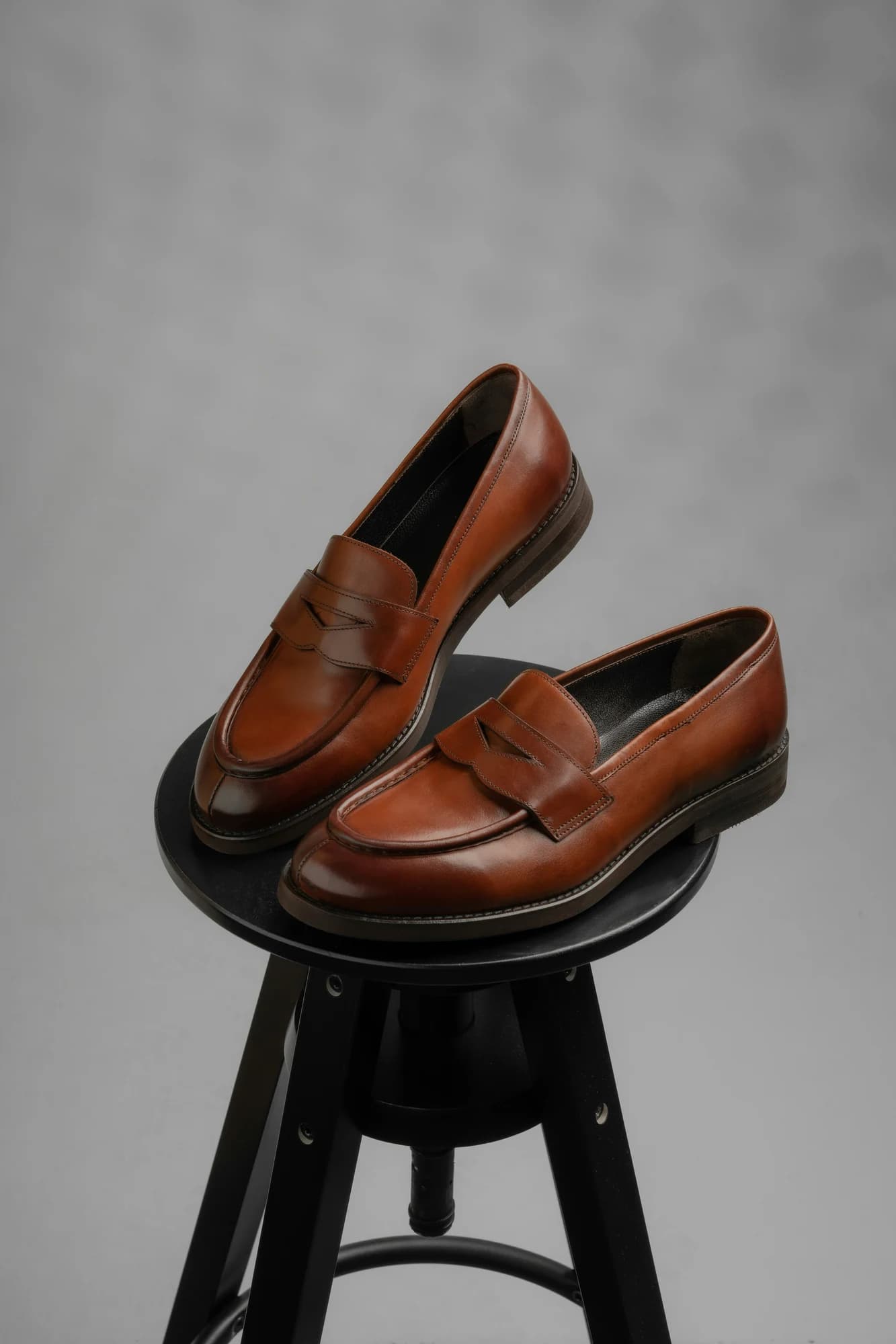 A pair of brown leather loafers on a stool. — representative photo, not taken at Hotter — Buchanan Galleries