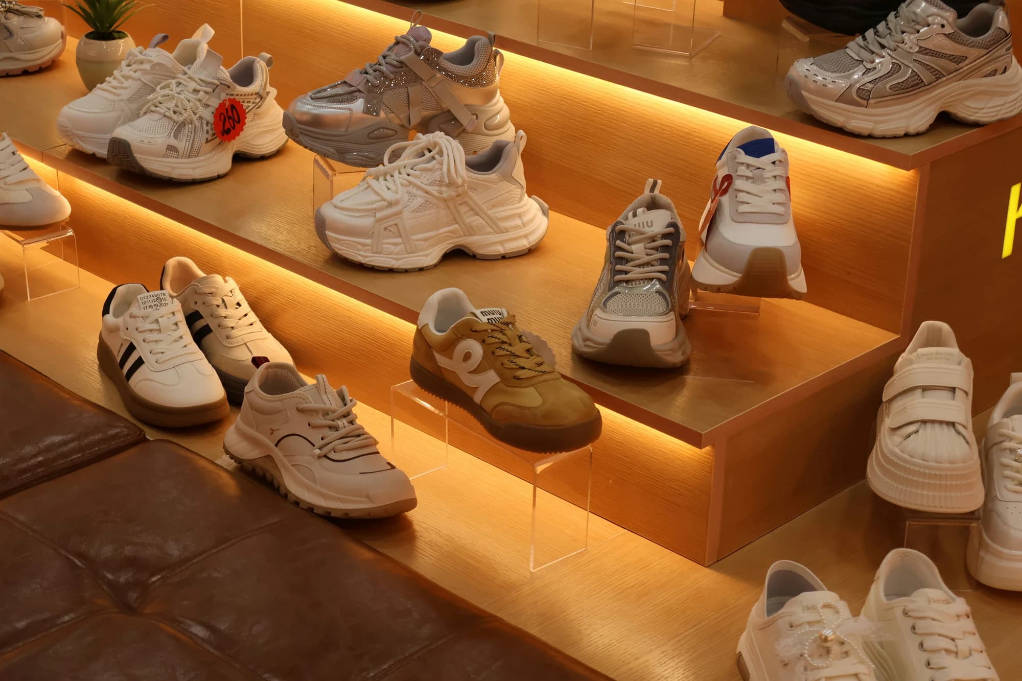 Various athletic shoes displayed on illuminated shelves. — representative photo, not taken at JD Sports — St. Enoch