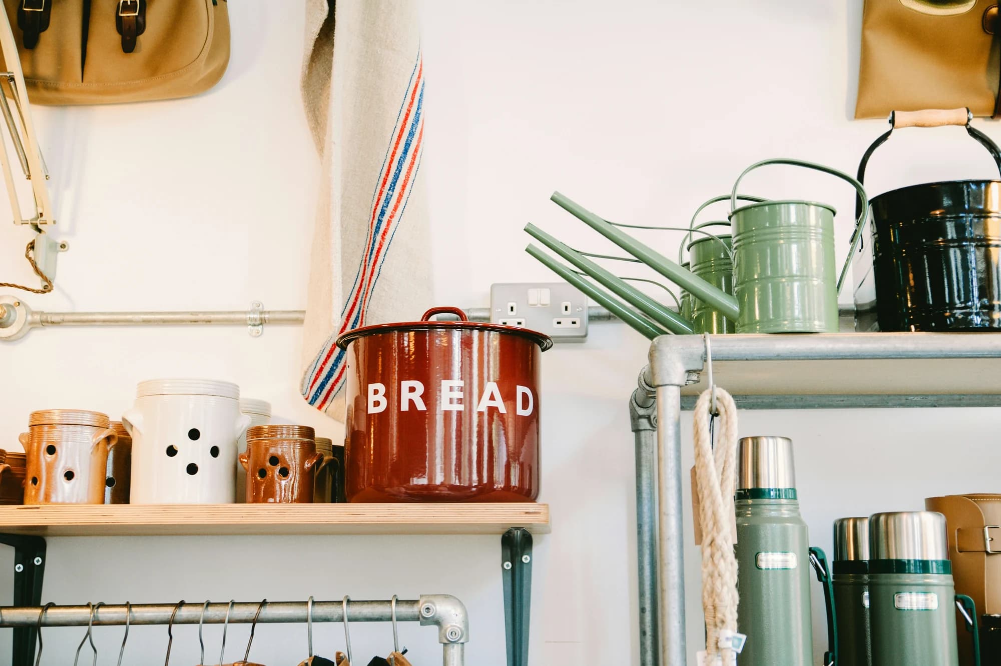 Assorted-color ceramic canister on beige wooden rack inside room — representative photo, not taken at John Lewis — Buchanan Galleries