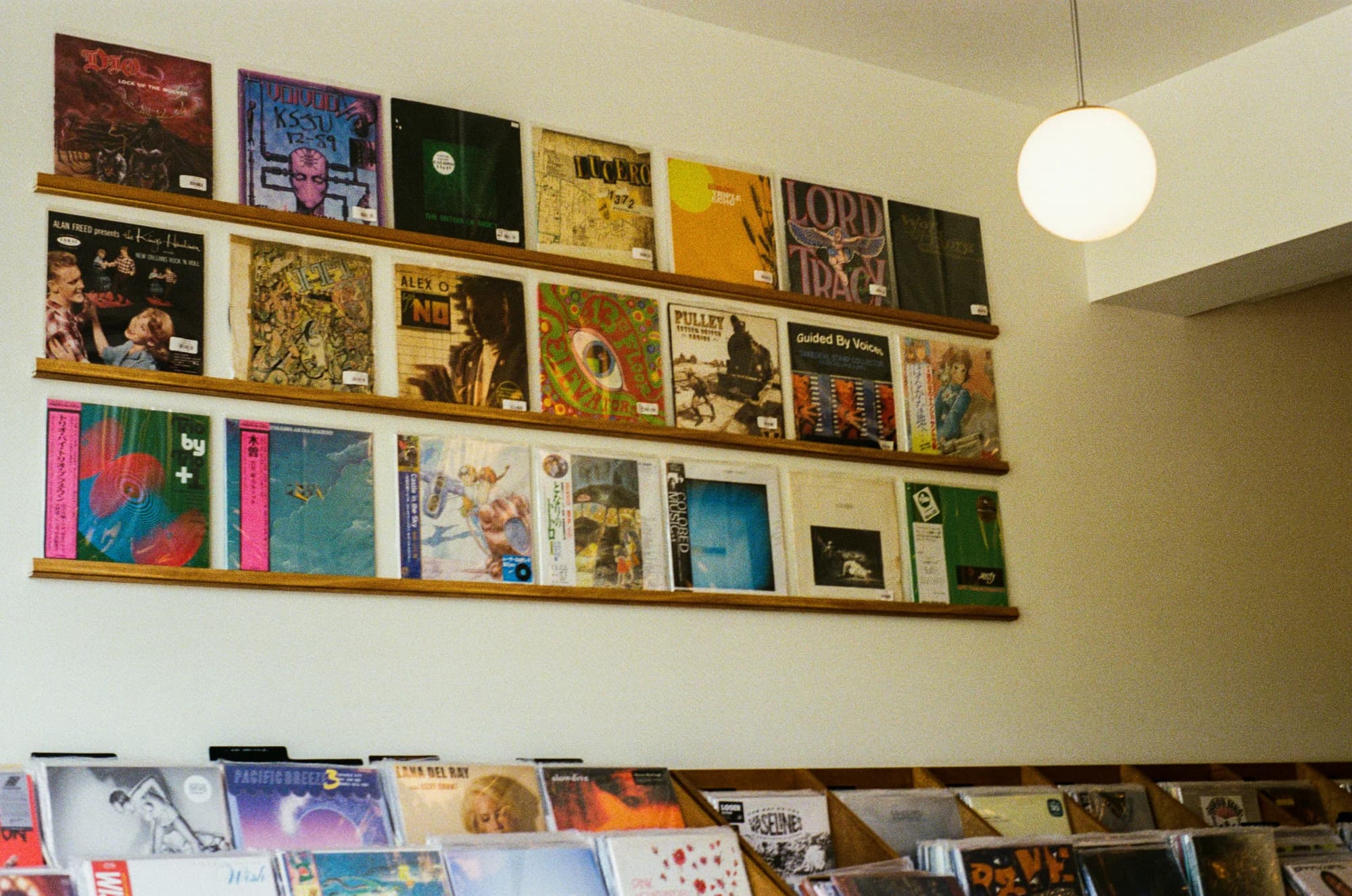 Vinyl records are displayed on shelves of a shop. — representative photo, not taken at Love Music