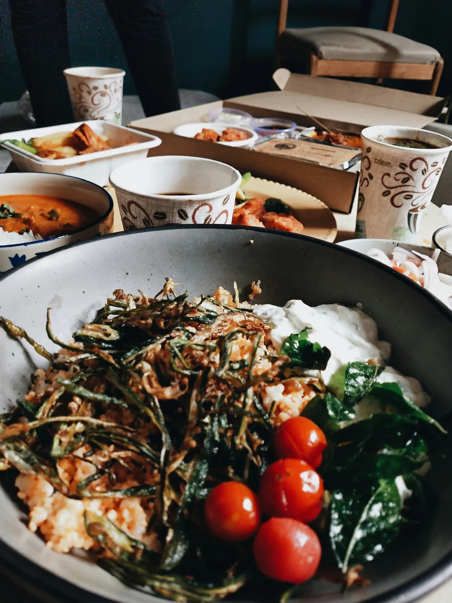 Rice dish with vegetables and yoghurt, with curry bowls on the table — representative photo, not taken at Masala Twist — Hope Street