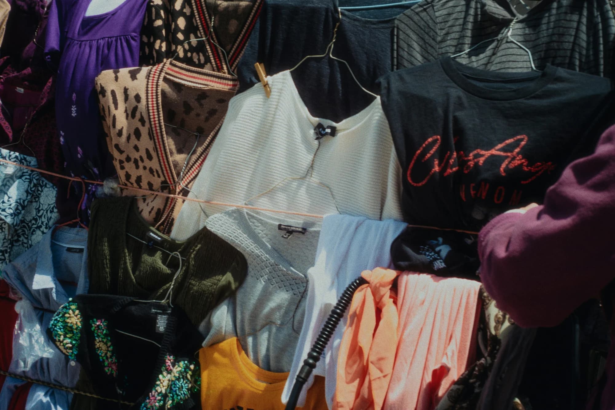 Clothes hang on a rack in a clothing store. — representative photo, not taken at Next — Buchanan Galleries