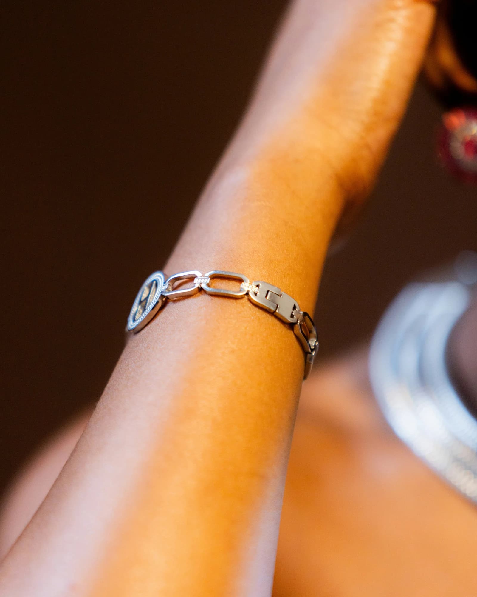 A silver bracelet adorns a person's wrist. — representative photo, not taken at Pandora — Buchanan Galleries