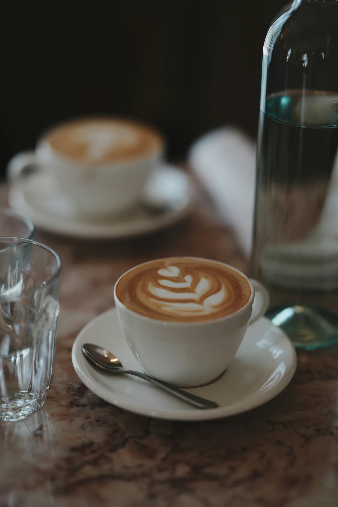 Latte with foam art — representative photo, not taken at Papercup Coffee