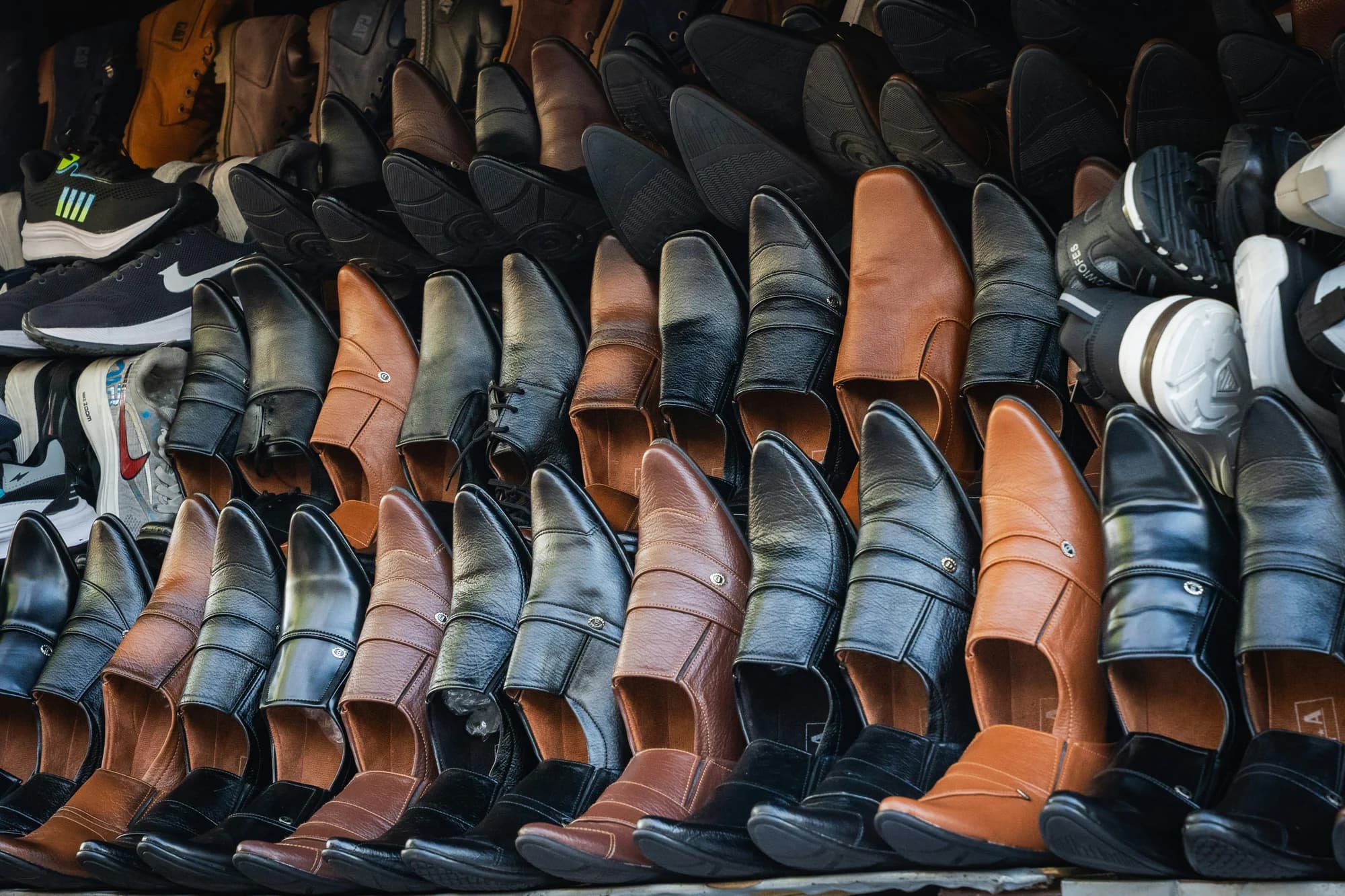 Rows of men's leather shoes displayed for sale. — representative photo, not taken at Pavers — St. Enoch