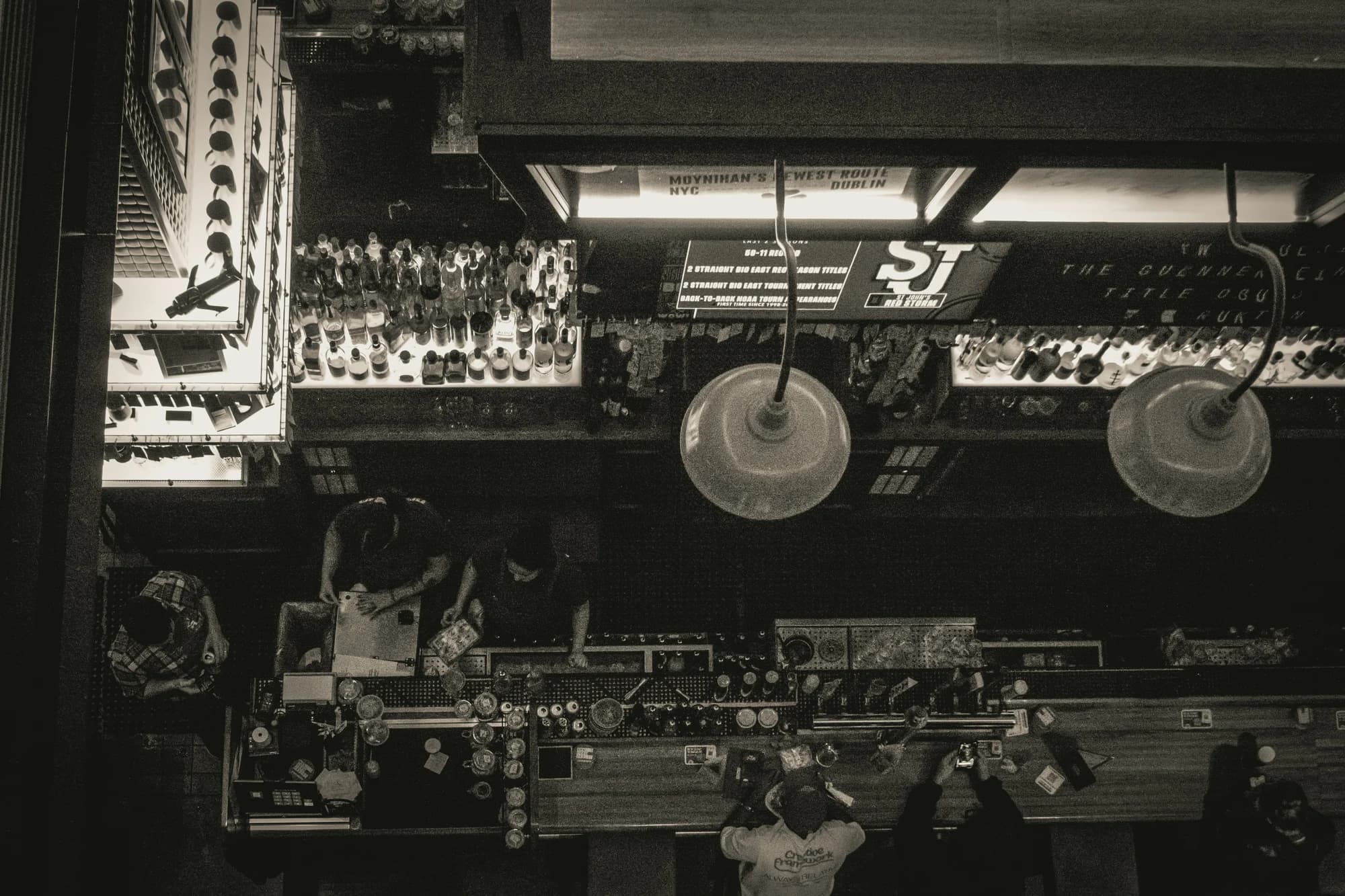 Bar interior with bottles and hanging lamps — representative photo, not taken at Ralph and Finns