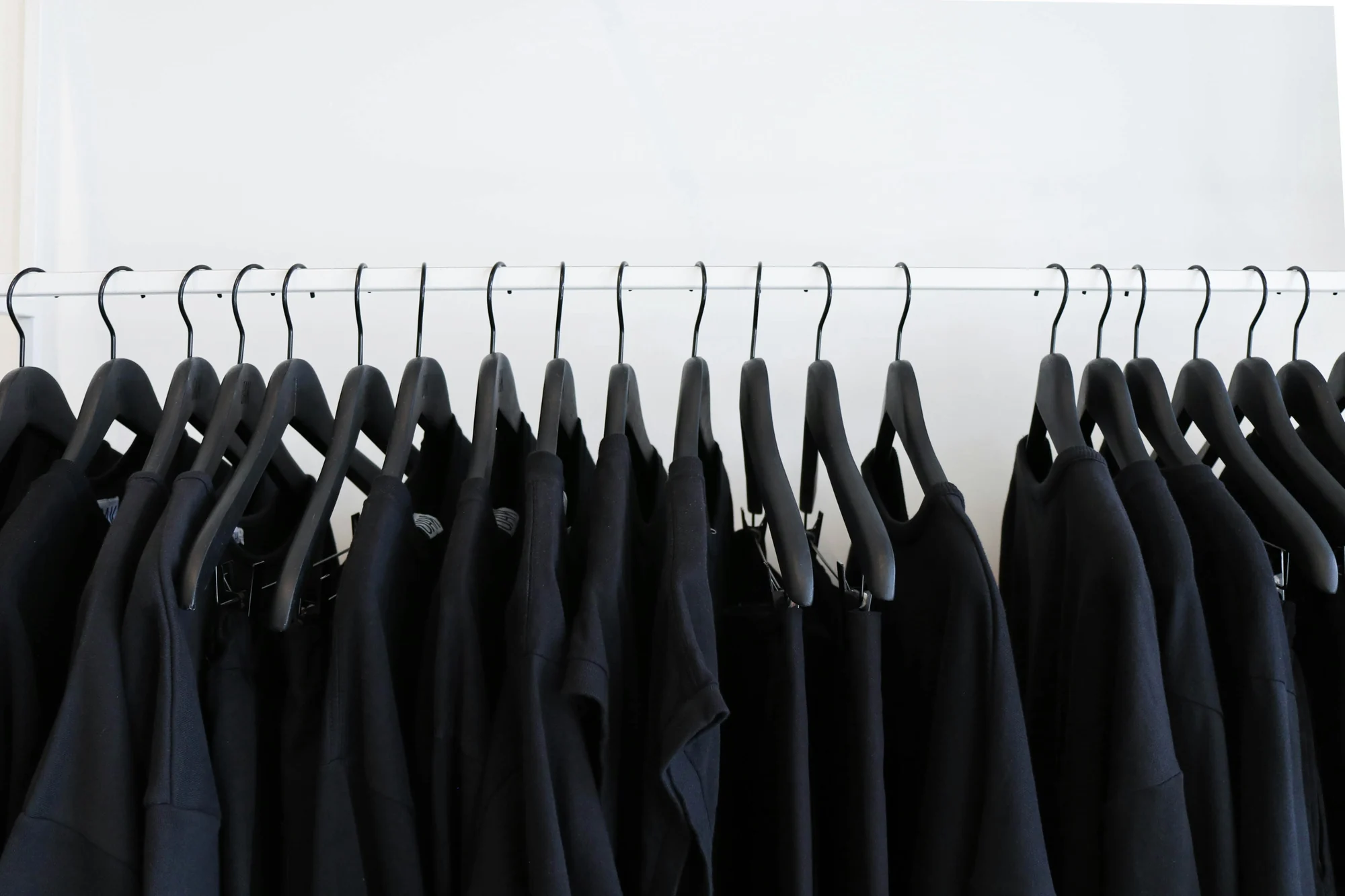 Black clothes hanged in rack — representative photo, not taken at Red Torpedo — St. Enoch
