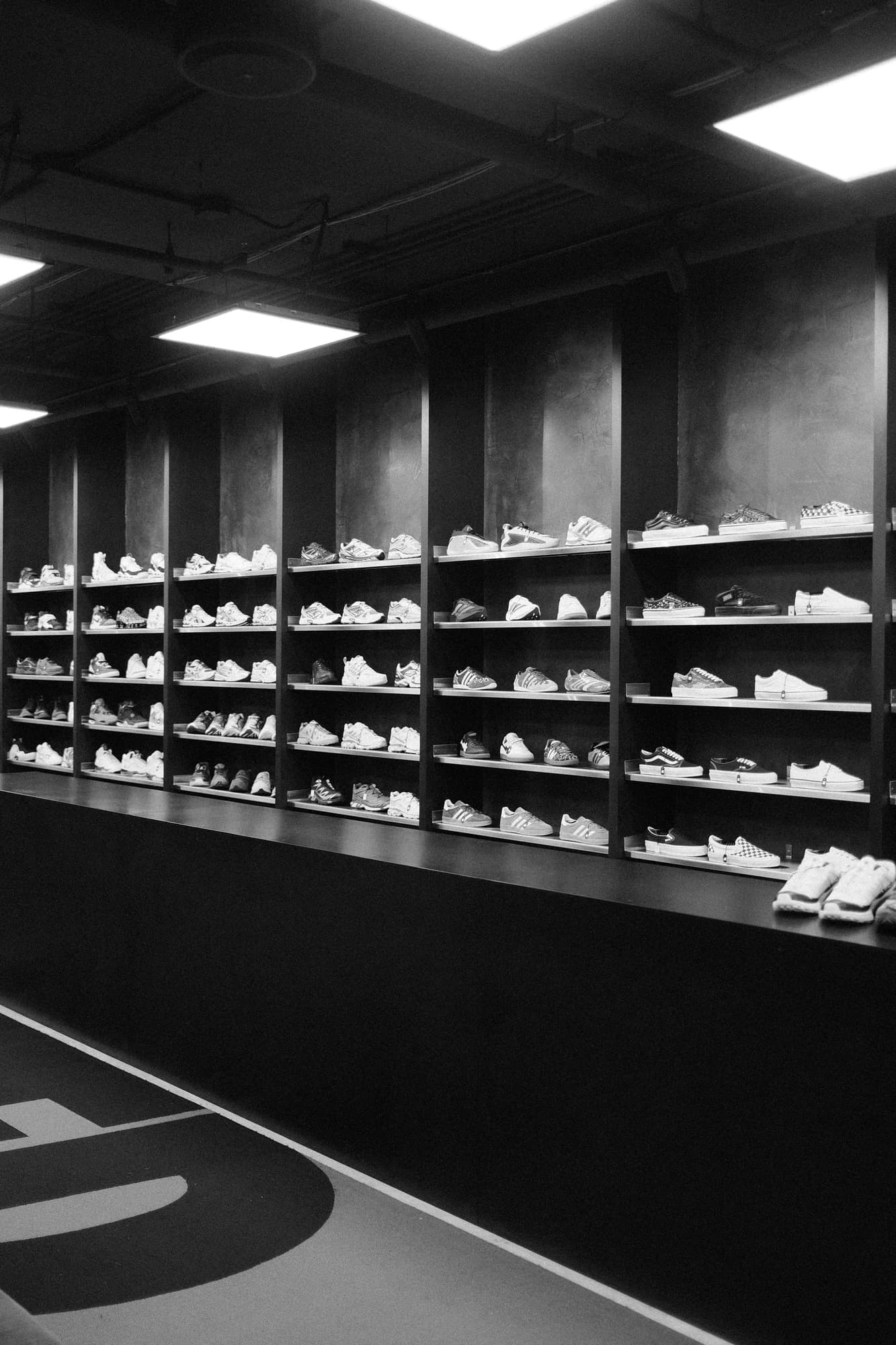Rows of sneakers displayed on shelves in a store. — representative photo, not taken at Restock3d — St. Enoch