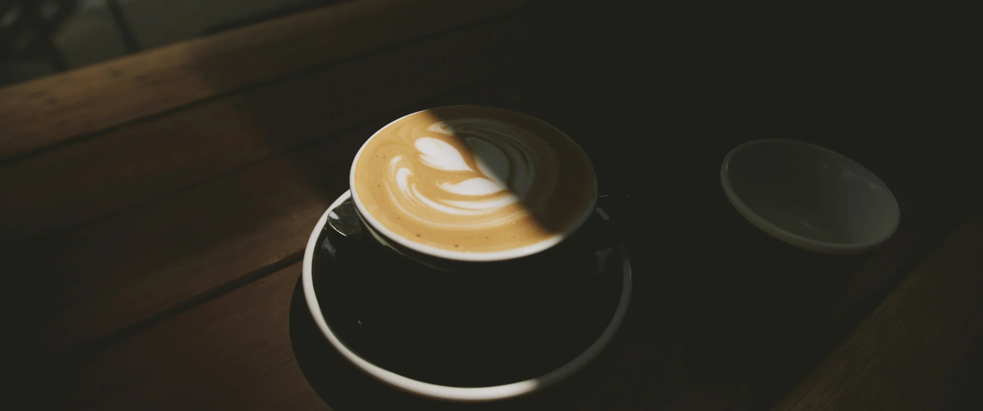 Latte in a dark mug — representative photo, not taken at Starbucks — St. Enoch
