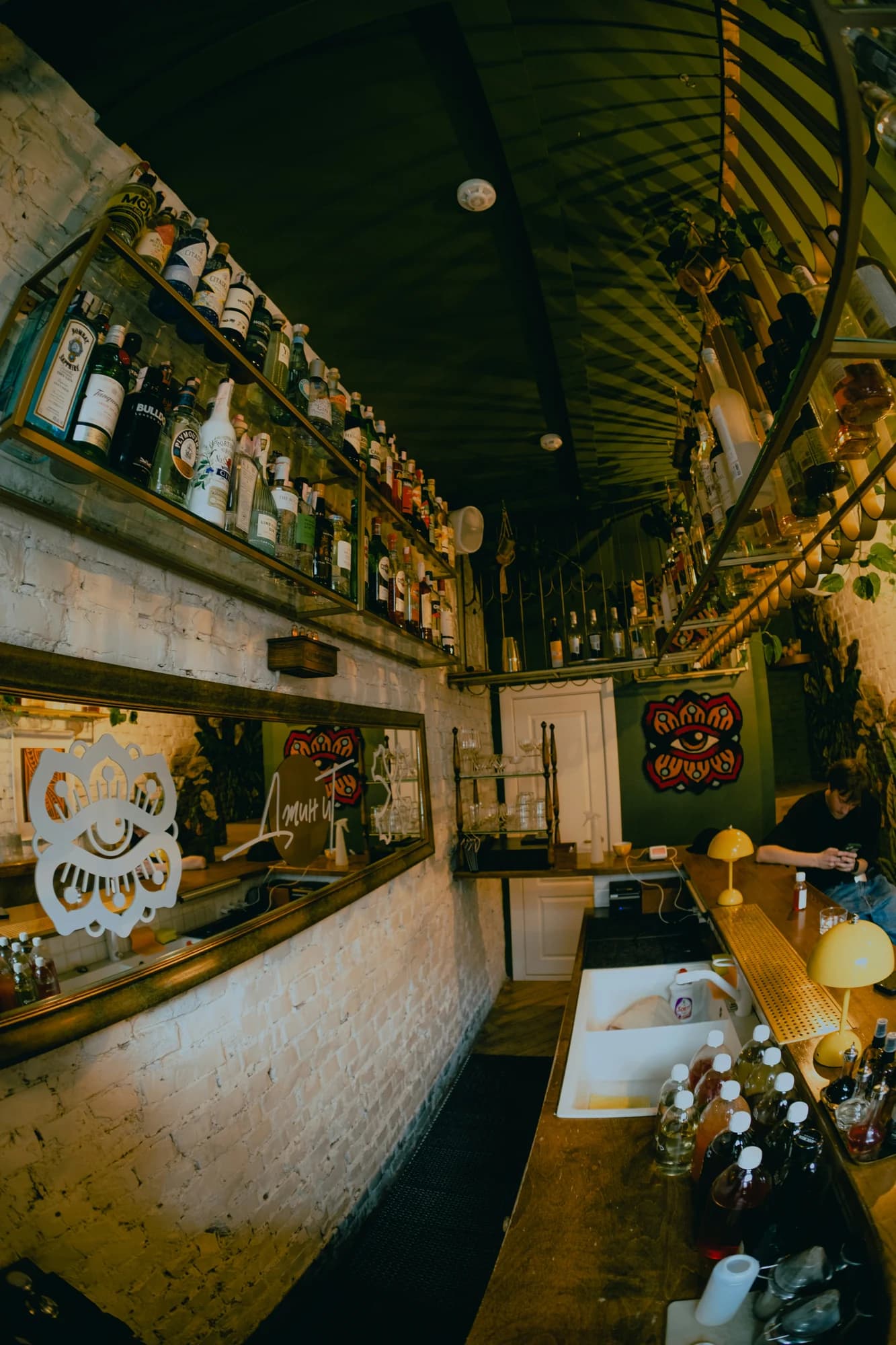Bar interior with shelves full of bottles and a counter. — representative photo, not taken at The Devil of Brooklyn