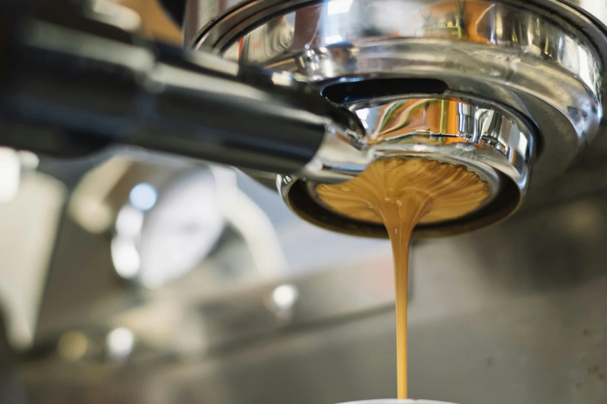 Coffee pouring from an espresso machine — representative photo, not taken at The Glad Cafe