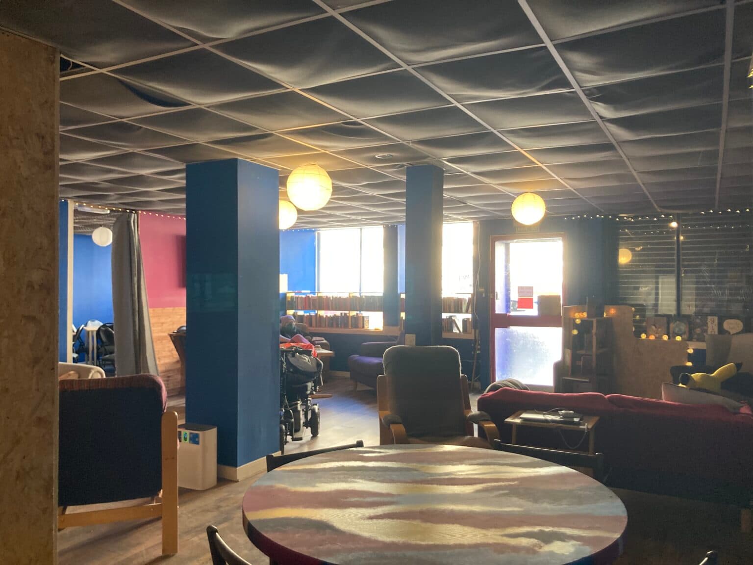 Reading room and seating inside Pluto Q, Govanhill
