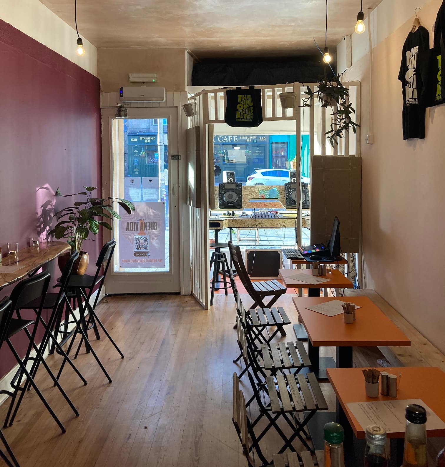 Tables and radio equipment inside Café Buena Vida on Victoria Road